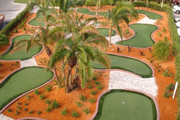 Pittsburgh Aerial view of a mini golf course with synthetic grass and palm trees.