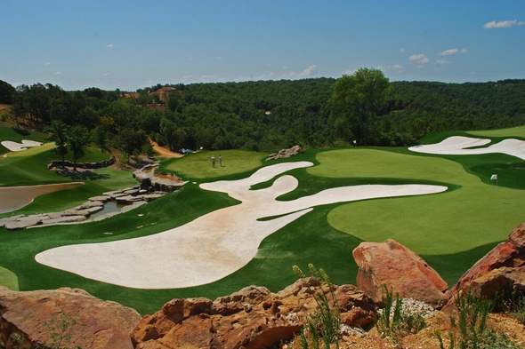 Pittsburgh lush green synthetic grass golf course with white sand bunkers and blue sky